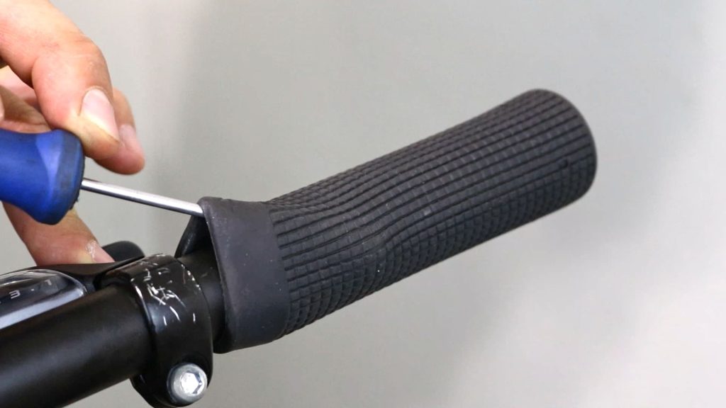 fitting screwdriver under the handlebar grip