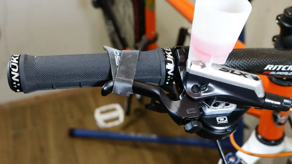 press the brake lever and secure it with a strap